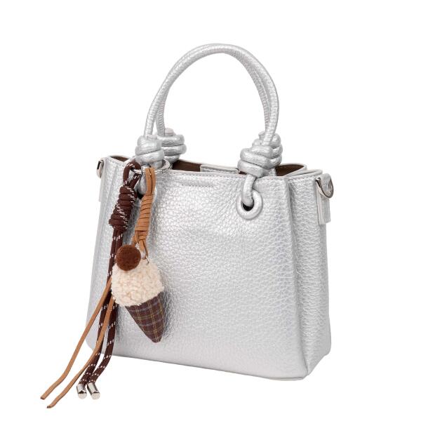 A stylish handbag with a decorative charm. image 0