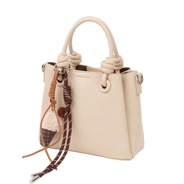A stylish handbag with a decorative charm. image 5